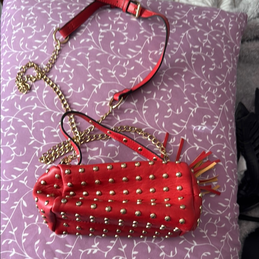 Woman’s little red studded purse crossbody